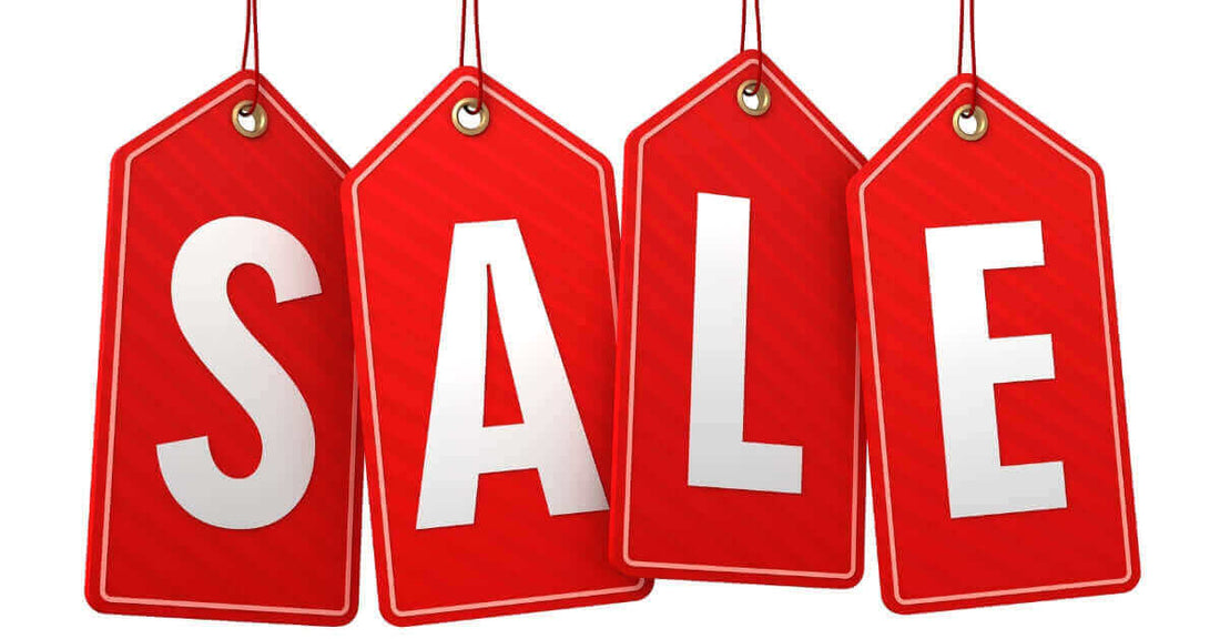 Hang tag label printing showcasing red sale tags with bold letters for marketing purposes.