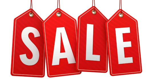 Bright red sale label tags hanging, promoting special offers and discounts for products.