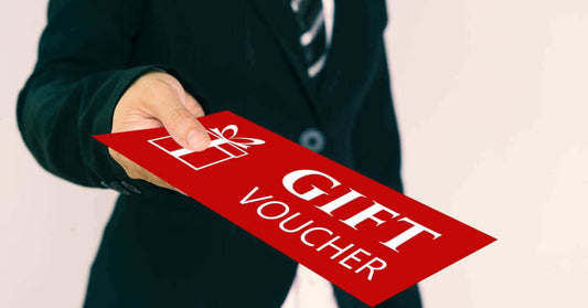 Person handing over a red gift voucher, showing example of voucher printing in Singapore.