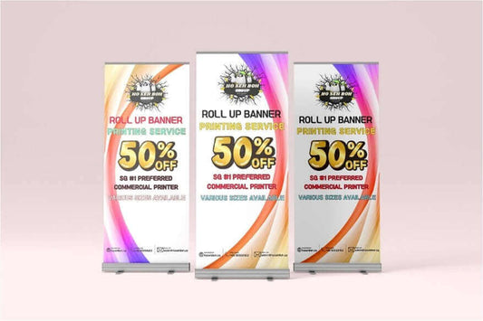 Three roll up banner printing displays promoting 50% off services for events and promotions, colorful design.