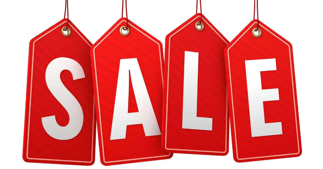 Bright red sale label tags hanging, promoting special offers and discounts for products.