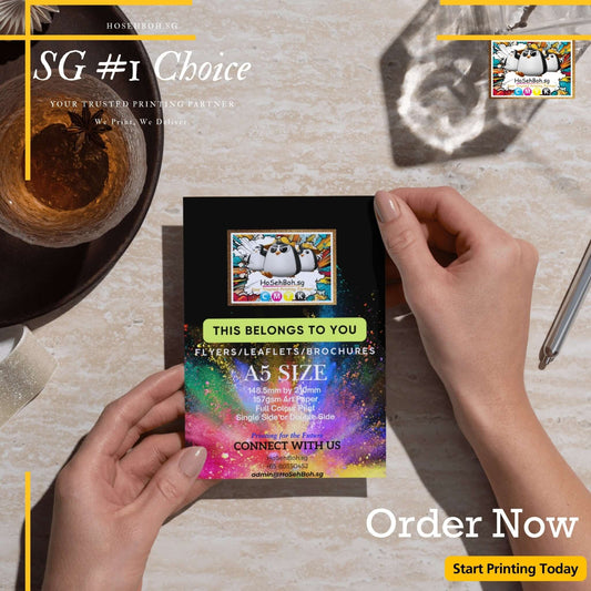 Person holding a vibrant A5 flyer promoting cheap printing services in Singapore.