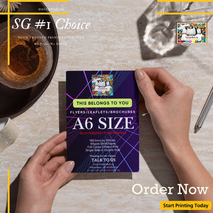 A6 size flyer in hand, showcasing cheapest flyer printing in Singapore. Perfect for effective marketing. Order now!